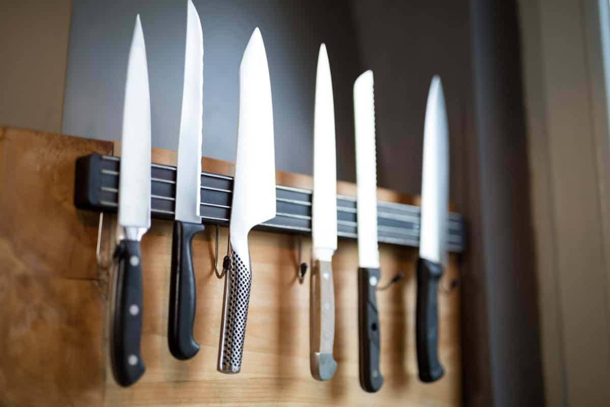 Set of kitchen knives hanging on the wall