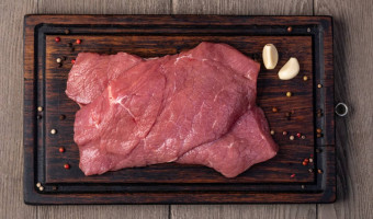 raw meat on wooden cutting board