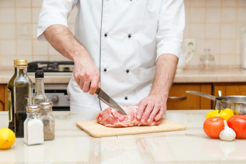 Butcher cutting meat 