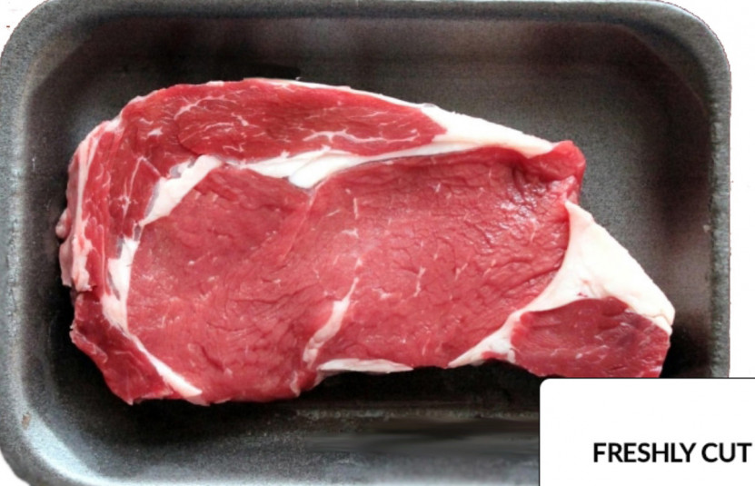 Freshly cut steak on black tray